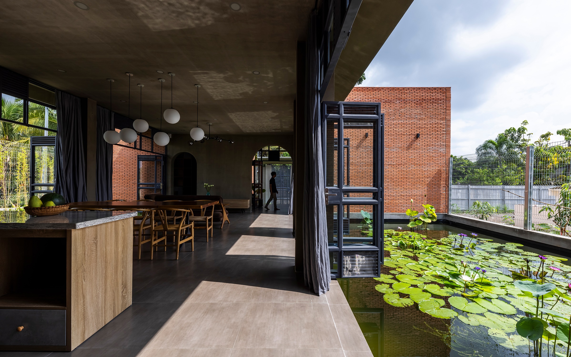 nha gach phong khach nha bep Nam House hien dai nhiet doi CTA | Creative Architects